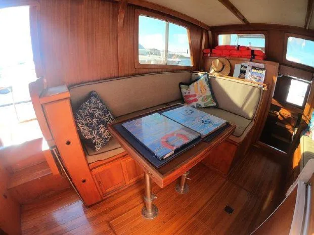 Slide: The Image of Interior of 1977 CHB 34 Double Cabin boat with wooden furnishings and cozy seating area. - 19