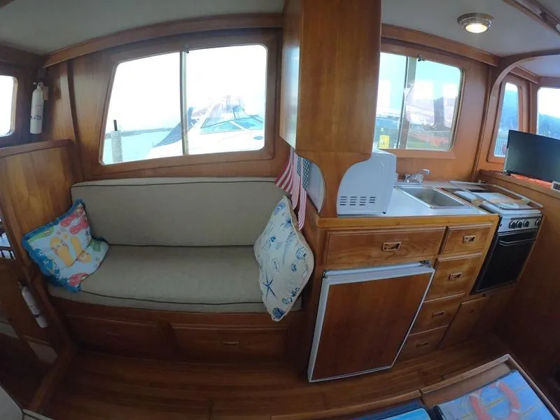 Slide: The Image of 1977 CHB 34 Double Cabin interior with kitchenette and seating area. - 22