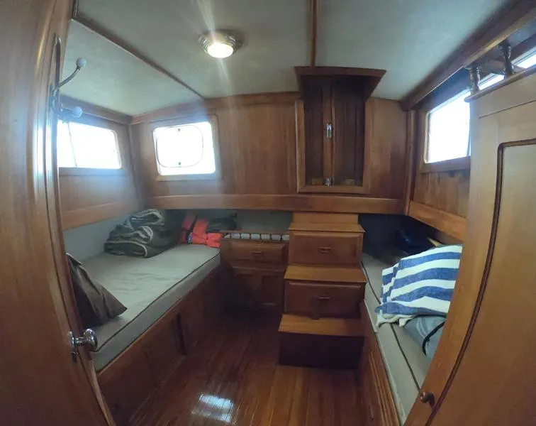 Slide: The Image of 1977 CHB 34 Double Cabin interior with wooden furnishings and twin beds. - 23