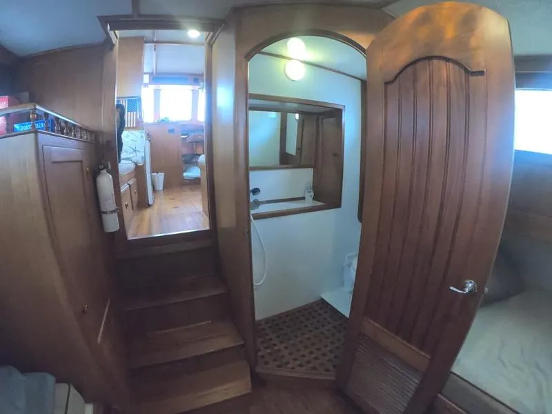Slide: The Image of 1977 CHB 34 Double Cabin interior with wooden finishes and compact bathroom. - 25