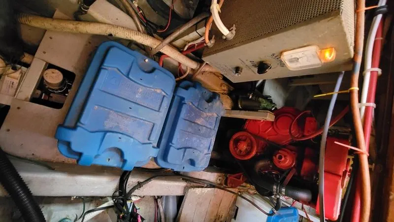 Slide: The Image of Engine room of a 1977 CHB 34 Double Cabin boat with blue battery covers. - 28