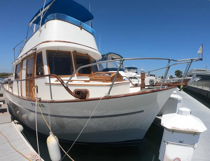Slide: The Image of 1977 CHB 34 Double Cabin boat docked at a marina on a sunny day. - 32