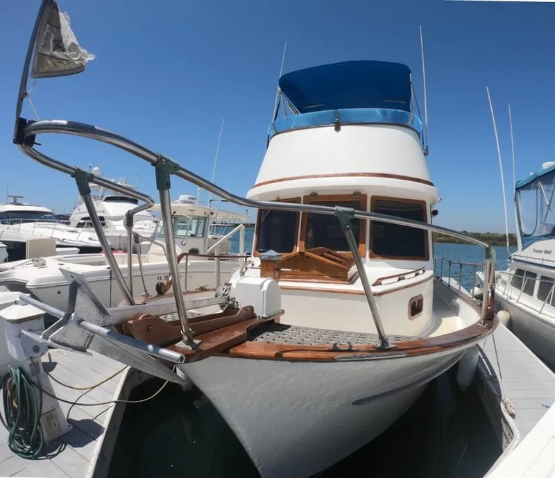 Slide: The Image of 1977 CHB 34 Double Cabin boat docked at a marina on a sunny day. - 33