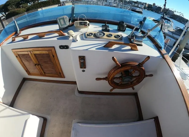 Slide: The Image of 1977 CHB 34 Double Cabin boat helm with wooden wheel and control panel. - 35