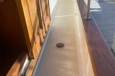 Slide: The Image of 1977 CHB 34 Double Cabin boat deck with wooden door and railing. - 40