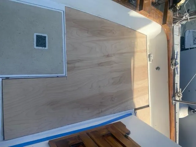 Slide: The Image of 1977 CHB 34 Double Cabin boat deck with wooden flooring and hatch. - 43
