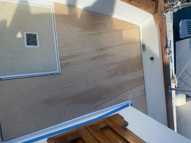 Slide: The Image of 1977 CHB 34 Double Cabin boat deck with wooden flooring and hatch. - 45