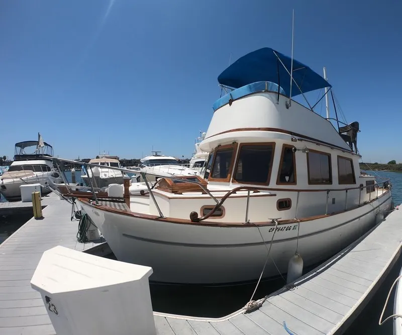 Slide: The Image of 1977 CHB 34 Double Cabin yacht docked at marina under clear blue sky. - 5