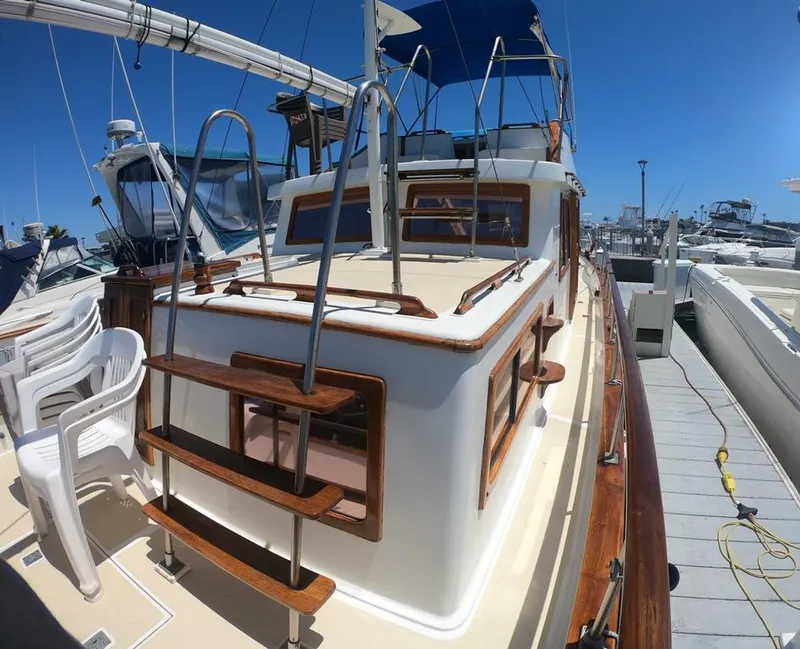 Slide: The Image of 1977 CHB 34 Double Cabin boat docked at a marina on a sunny day. - 9