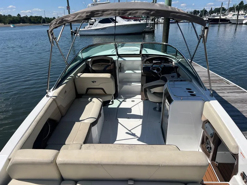 Slide: The Image of 2015 Monterey 268 SC boat with beige seating docked at a marina. - 10