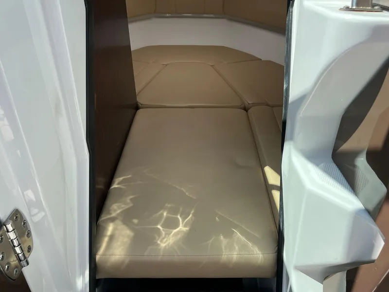 Slide: The Image of 2015 Monterey 268 SC cabin interior with beige cushioned seating. - 13