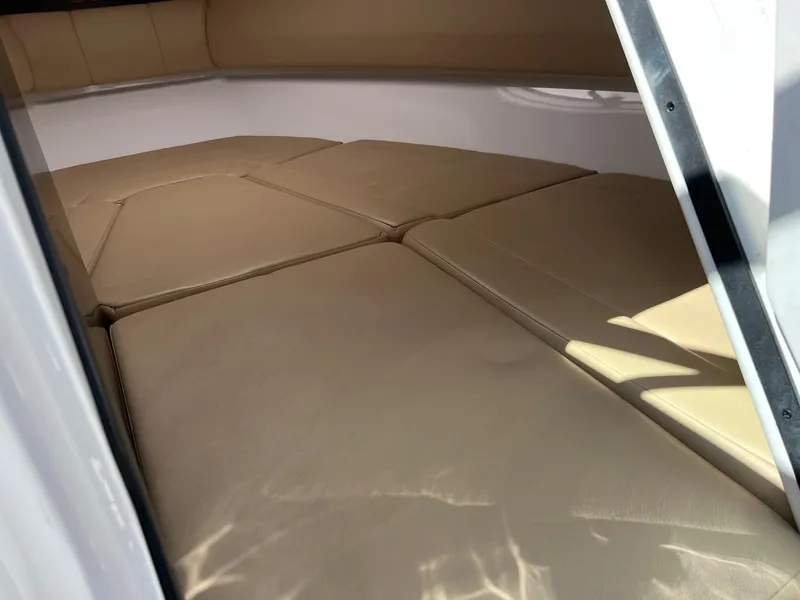 Slide: The Image of Interior cabin of a 2015 Monterey 268 SC boat with beige cushions. - 14