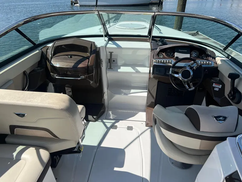 Slide: The Image of 2015 Monterey 268 SC boat interior with steering wheel and seating. - 19