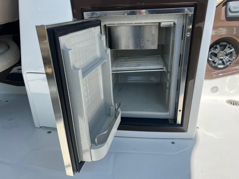 Slide: The Image of Open mini fridge on a 2015 Monterey 268 SC boat. - 21