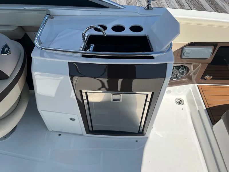 Slide: The Image of 2015 Monterey 268 SC boat kitchenette with sink and storage. - 22