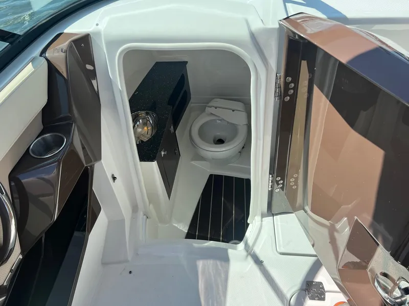 Slide: The Image of 2015 Monterey 268 SC boat interior with compact bathroom and toilet. - 28