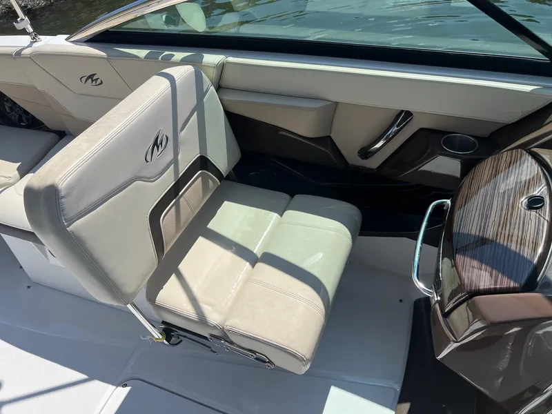 Slide: The Image of 2015 Monterey 268 SC boat interior with beige seating and steering console. - 29
