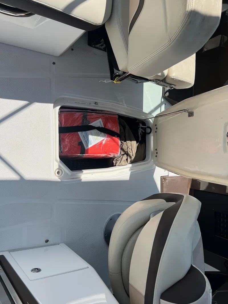 Slide: The Image of 2015 Monterey 268 SC boat interior storage compartment with life jackets. - 30