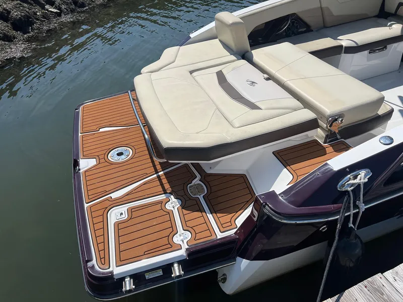 Slide: The Image of 2015 Monterey 268 SC boat with cushioned seating and teak deck at the stern. - 5
