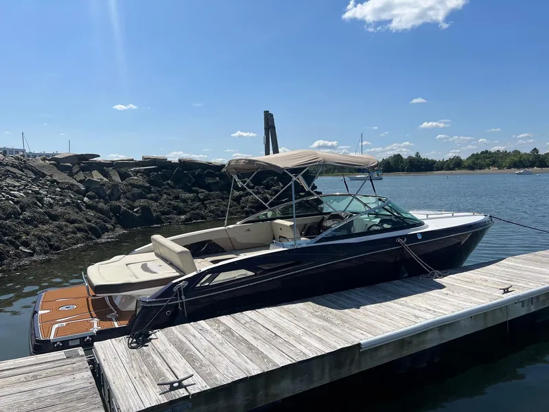 Slide: The Image of 2015 Monterey 268 SC boat docked at a marina on a sunny day. - 7