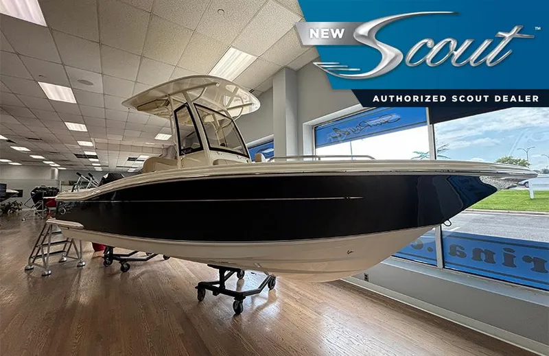 The Image of 2024 Scout 215 XSF boat displayed in showroom, authorized dealer signage visible. - 0
