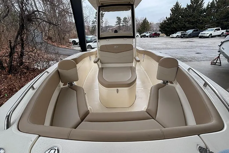 Slide: The Image of 2024 Scout 215 XSF boat interior with beige seating and spacious layout. - 17