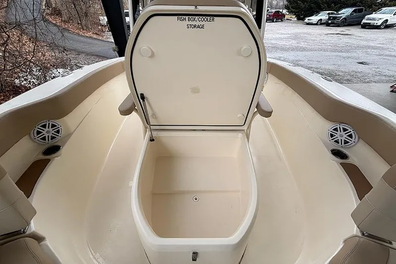 Slide: The Image of 2024 Scout 215 XSF boat with open fish box cooler storage. - 18