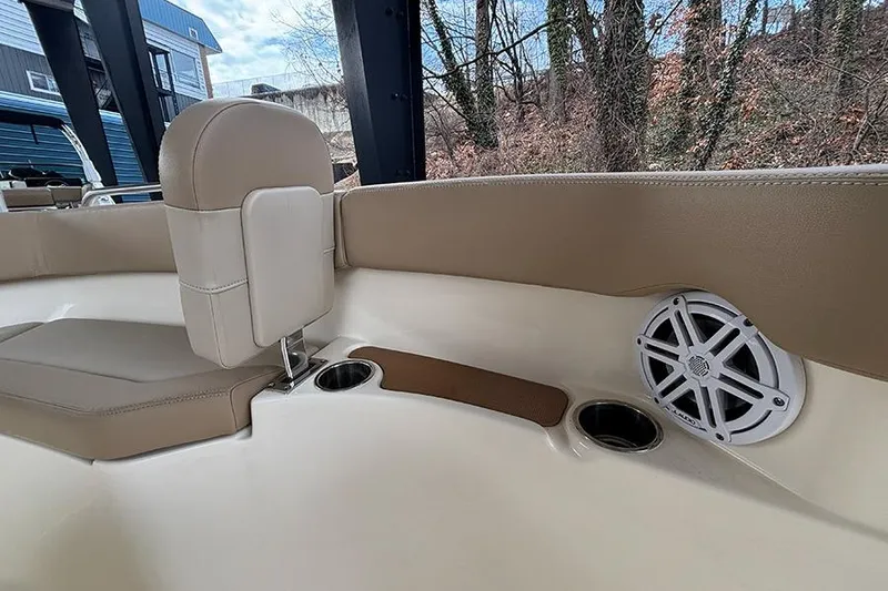 Slide: The Image of 2024 Scout 215 XSF boat interior with beige seating, cup holders, and speaker. - 22