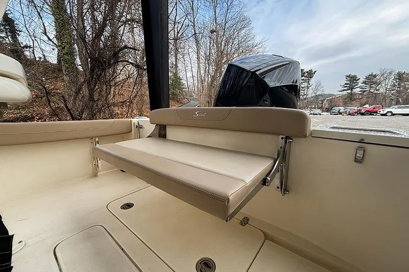 Slide: The Image of 2024 Scout 215 XSF boat interior with foldable seat and outboard motor. - 24