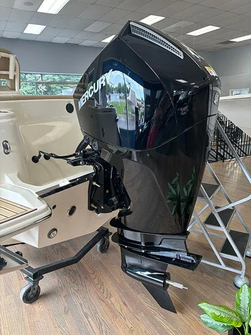 Slide: The Image of 2024 Scout 215 XSF boat with a Mercury outboard motor in showroom. - 7