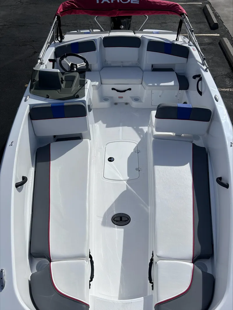 Slide: The Image of 2024 Tahoe T18 boat with spacious seating and red canopy. - 2