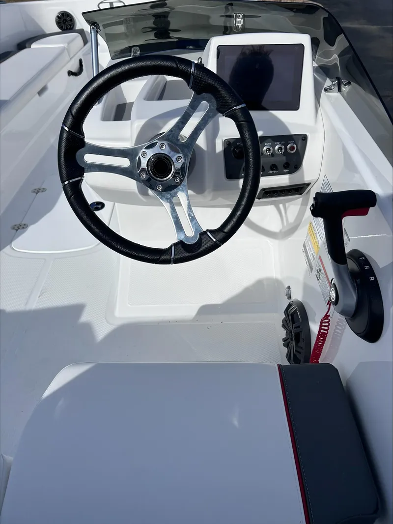 Slide: The Image of 2024 Tahoe T18 boat cockpit with steering wheel and control panel. - 5