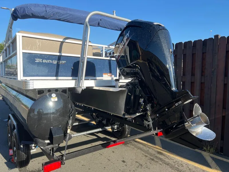 Slide: The Image of 2024 Ranger Reata 200C pontoon boat with outboard motor on trailer. - 3