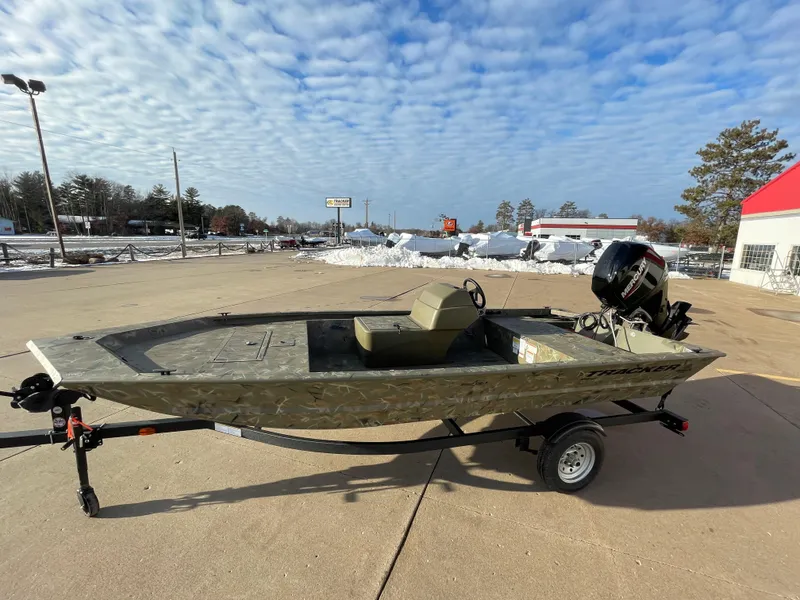 Slide: The Image of 2024 Tracker Grizzly 1648 SC boat on trailer in outdoor lot. - 3