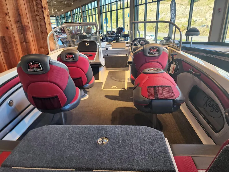 Slide: The Image of 2024 Ranger 1850MS boat interior with red and black seats, spacious layout, and modern dashboard. - 5