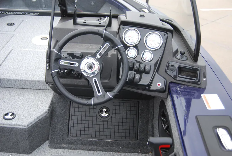 Slide: The Image of 2024 Tracker Targa V-19 Combo boat dashboard with steering wheel and gauges. - 7