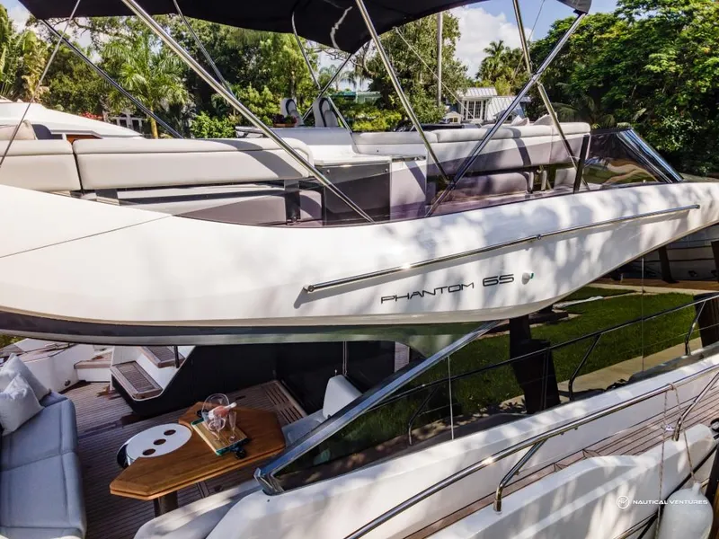Slide: The Image of 2023 Fairline Phantom 65 luxury yacht with outdoor seating and dining area. - 25