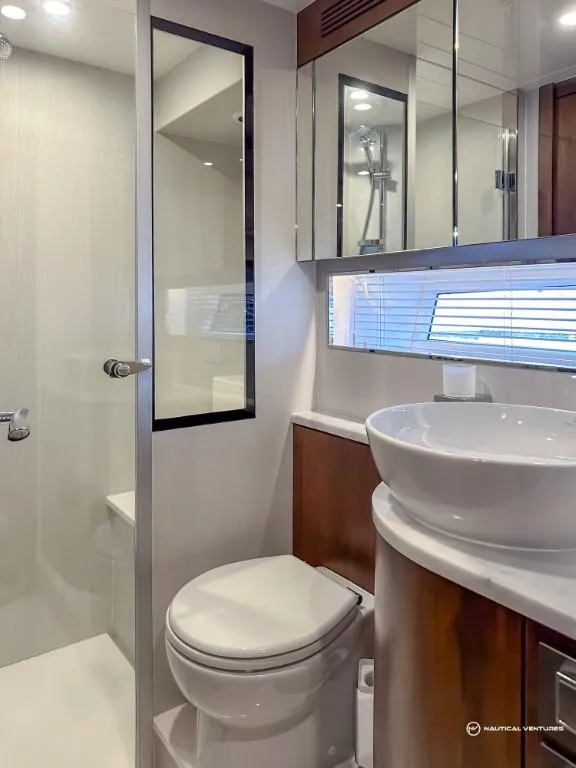 Slide: The Image of Modern bathroom in 2023 Fairline Phantom 65 yacht with shower, toilet, and sink. - 41