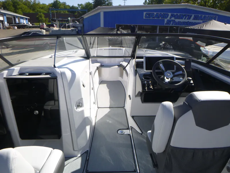 Slide: The Image of 2024 Yamaha Boats AR250 interior cockpit with steering wheel and seating. - 16