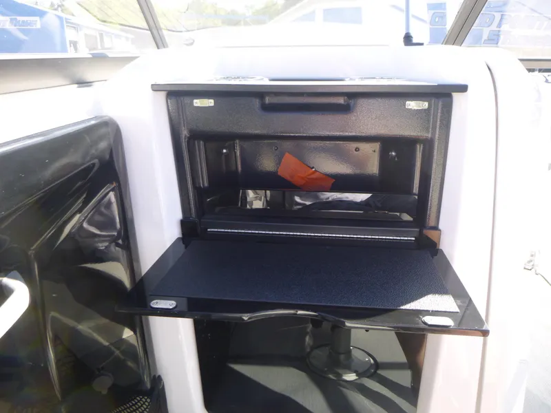 Slide: The Image of 2024 Yamaha Boats AR250 storage compartment with open hatch. - 17