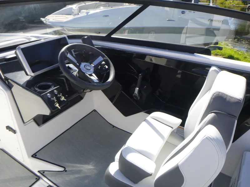 Slide: The Image of 2024 Yamaha Boats AR250 cockpit with modern steering wheel and dual seating. - 21