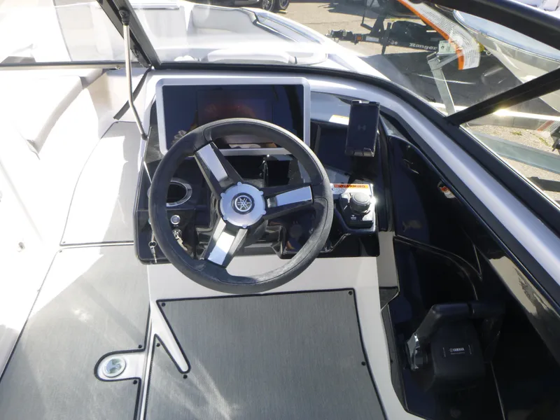 Slide: The Image of 2024 Yamaha Boats AR250 steering console with modern controls and touchscreen display. - 22