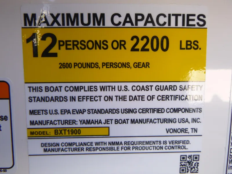 Slide: The Image of 2024 Yamaha Boats AR250 capacity label: 12 persons or 2200 lbs, meets USCG and EPA standards. - 23