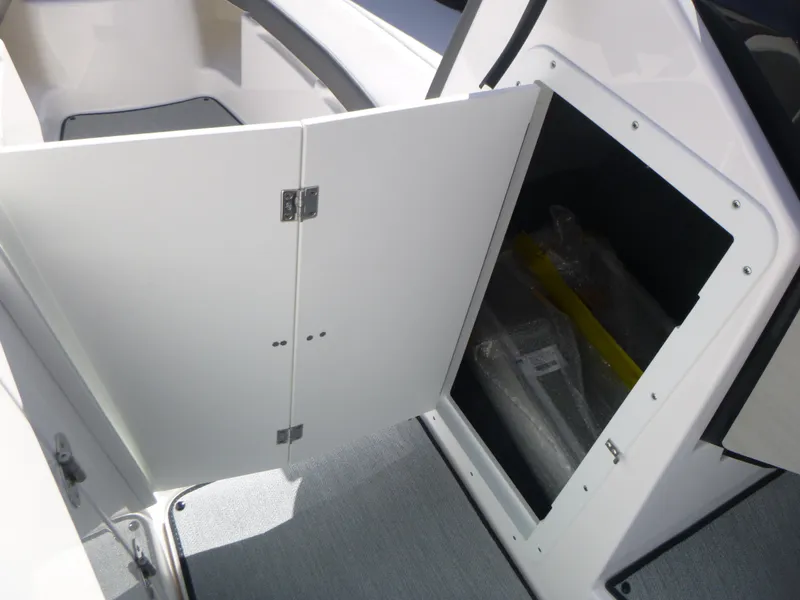 Slide: The Image of 2024 Yamaha Boats AR250 storage compartment with open door. - 26