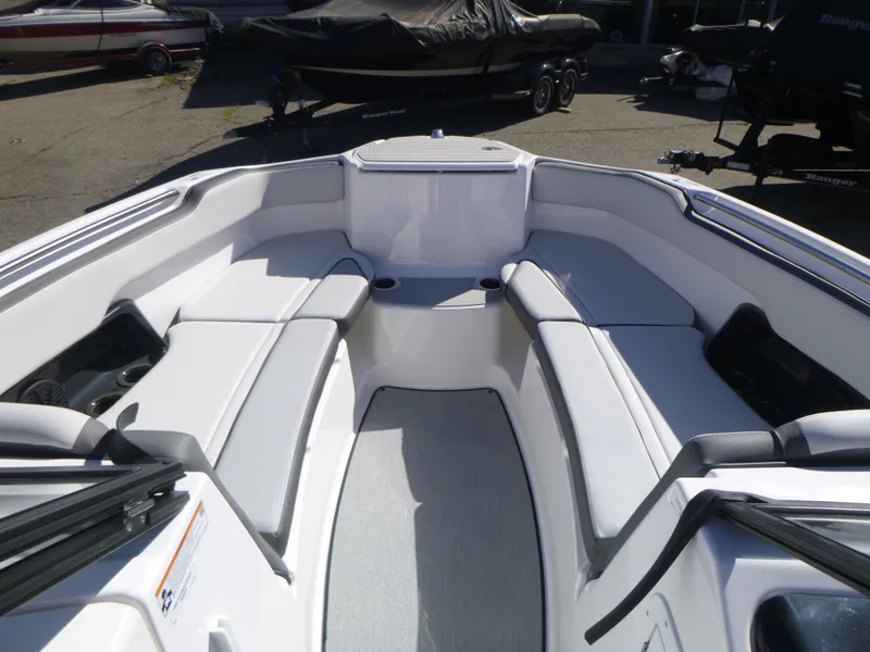 Slide: The Image of 2024 Yamaha Boats AR250 interior seating area with white upholstery. - 27
