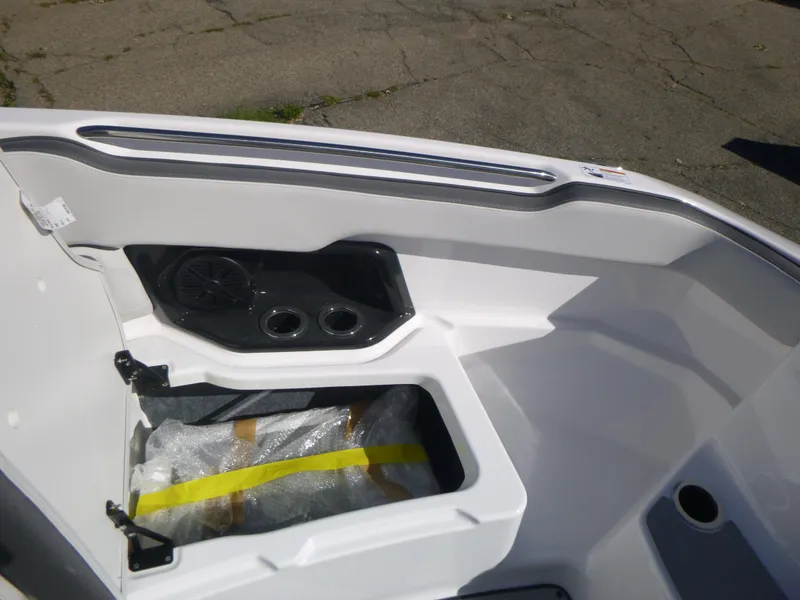 Slide: The Image of 2024 Yamaha Boats AR250 interior storage compartment and speaker system. - 28