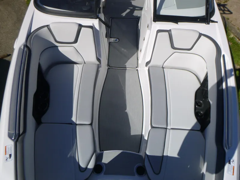 Slide: The Image of 2024 Yamaha Boats AR250 interior seating area with gray and white upholstery. - 34