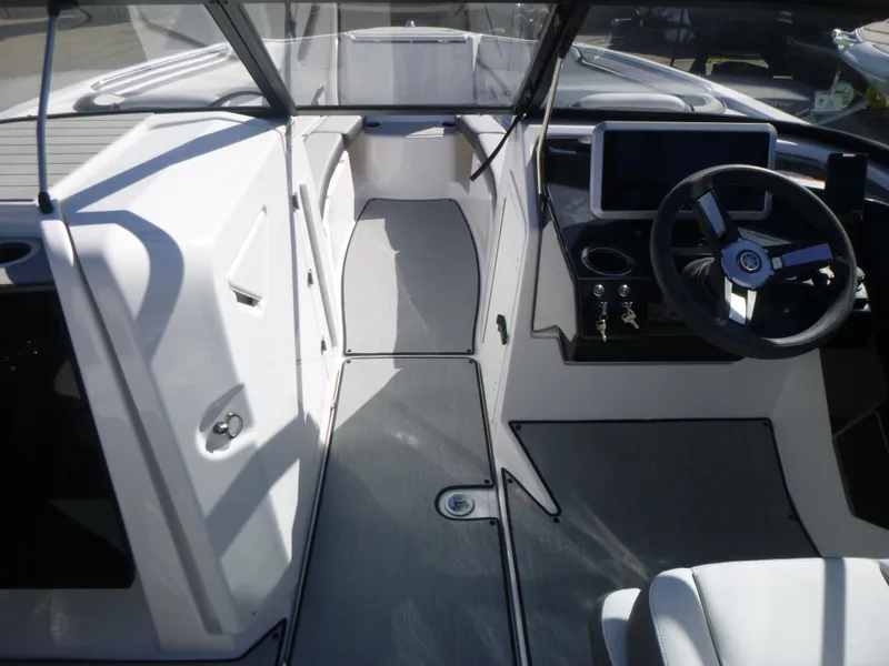 Slide: The Image of 2024 Yamaha Boats AR250 interior cockpit with steering wheel and dashboard. - 37