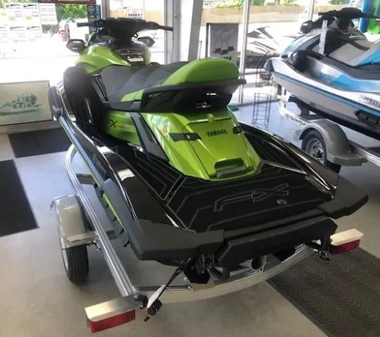 Slide: The Image of 2024 Yamaha WaveRunner FX Cruiser SVHO with Audio in showroom, green and black, on trailer. - 2
