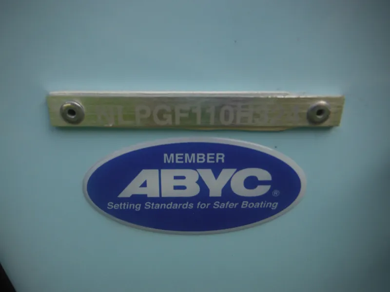 Slide: The Image of 2024 Tidewater 220 LXF boat with ABYC member sticker for safer boating standards. - 11